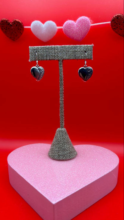 Heart-shaped gift box with decorative elements on a red background