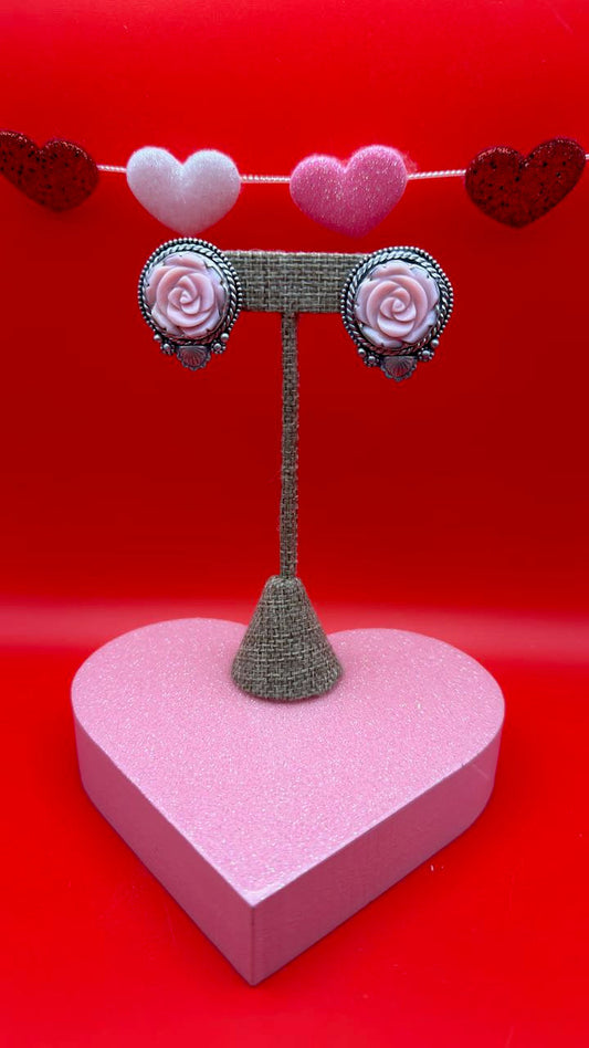 Decorative heart-shaped object with floral designs on a red background