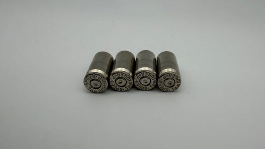 Four metallic cylindrical objects on a light gray background